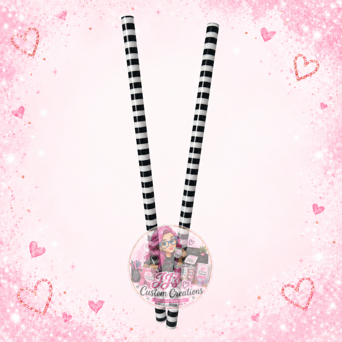 Two black and white striped reusable straws on JJ’s blush pink sparkle background