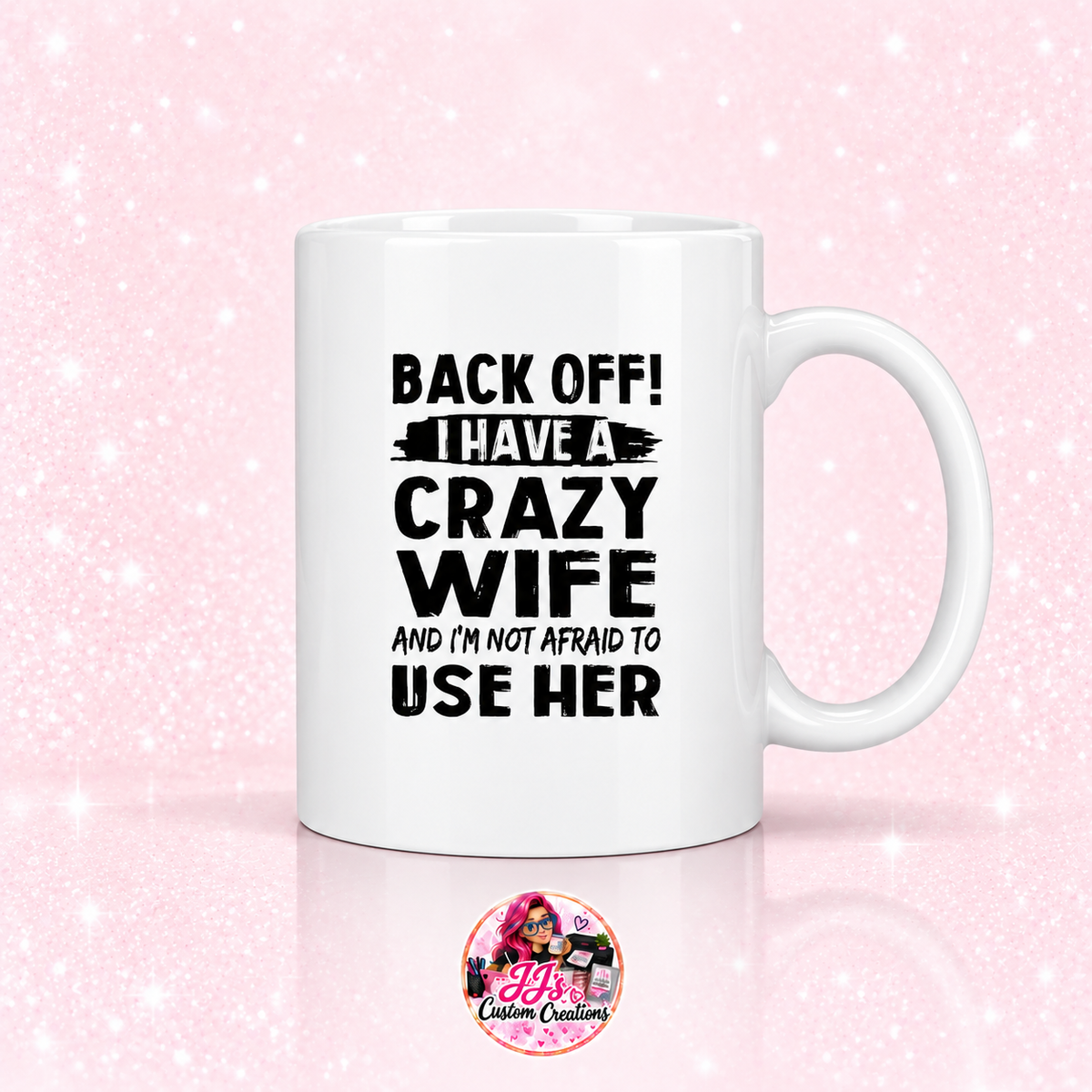 Crazy Wife ceramic mug on a light pale blush background with JJ's Custom Creations pink-haired logo