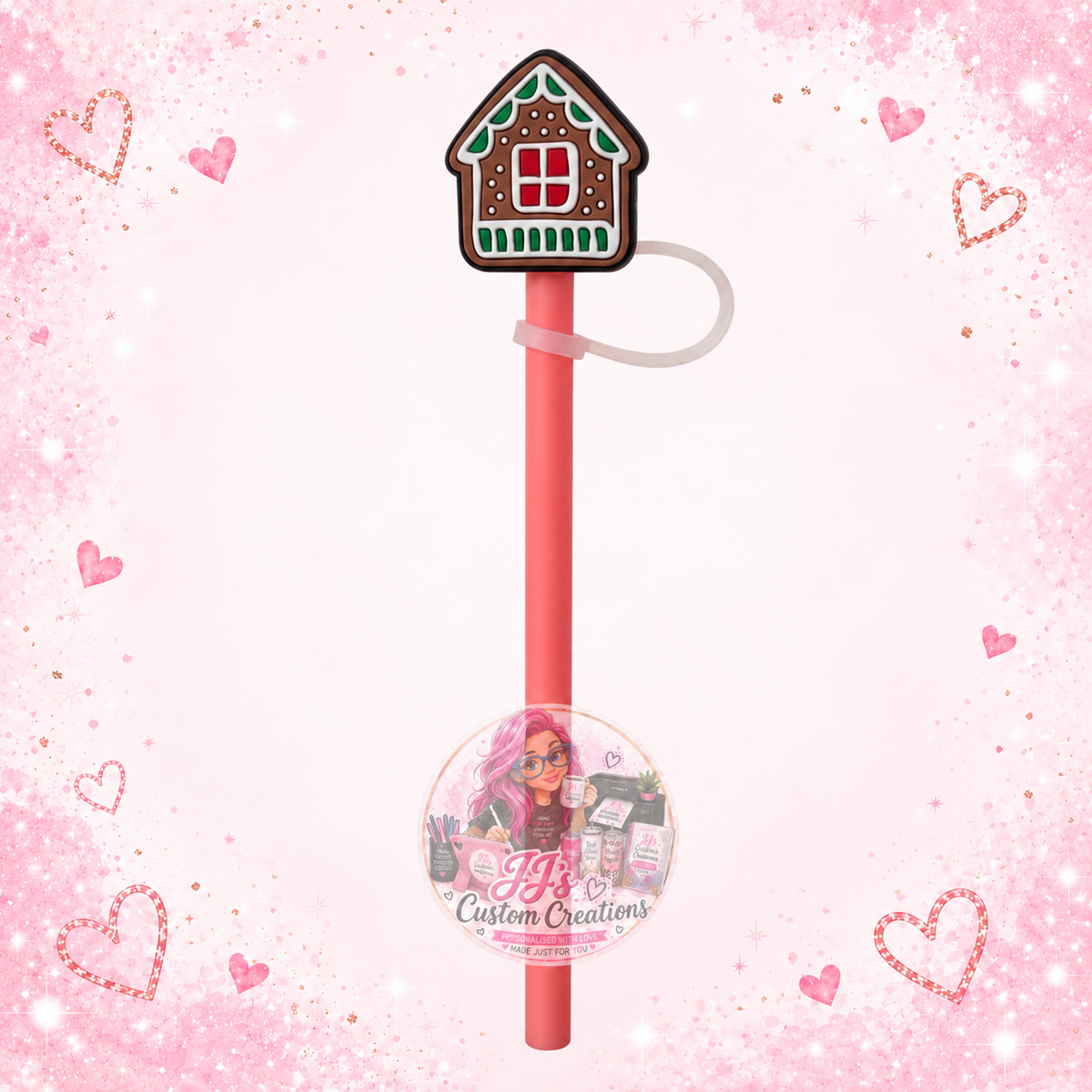 Gingerbread house straw topper with pink straw on JJ’s blush pink sparkle background