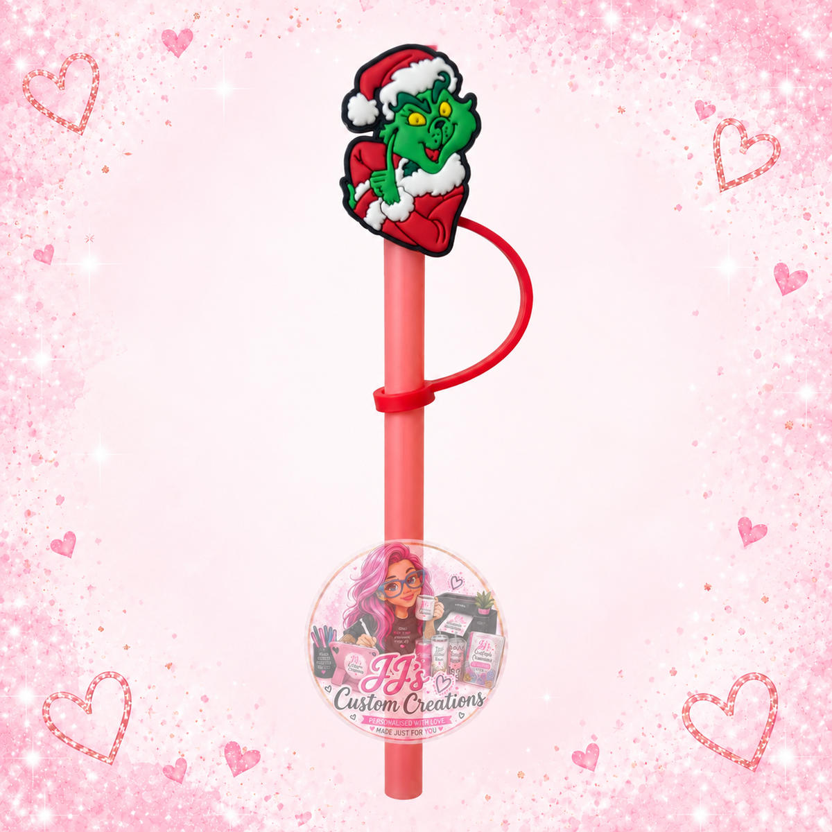 Green Christmas character straw topper with pink straw on JJ’s blush pink sparkle background
