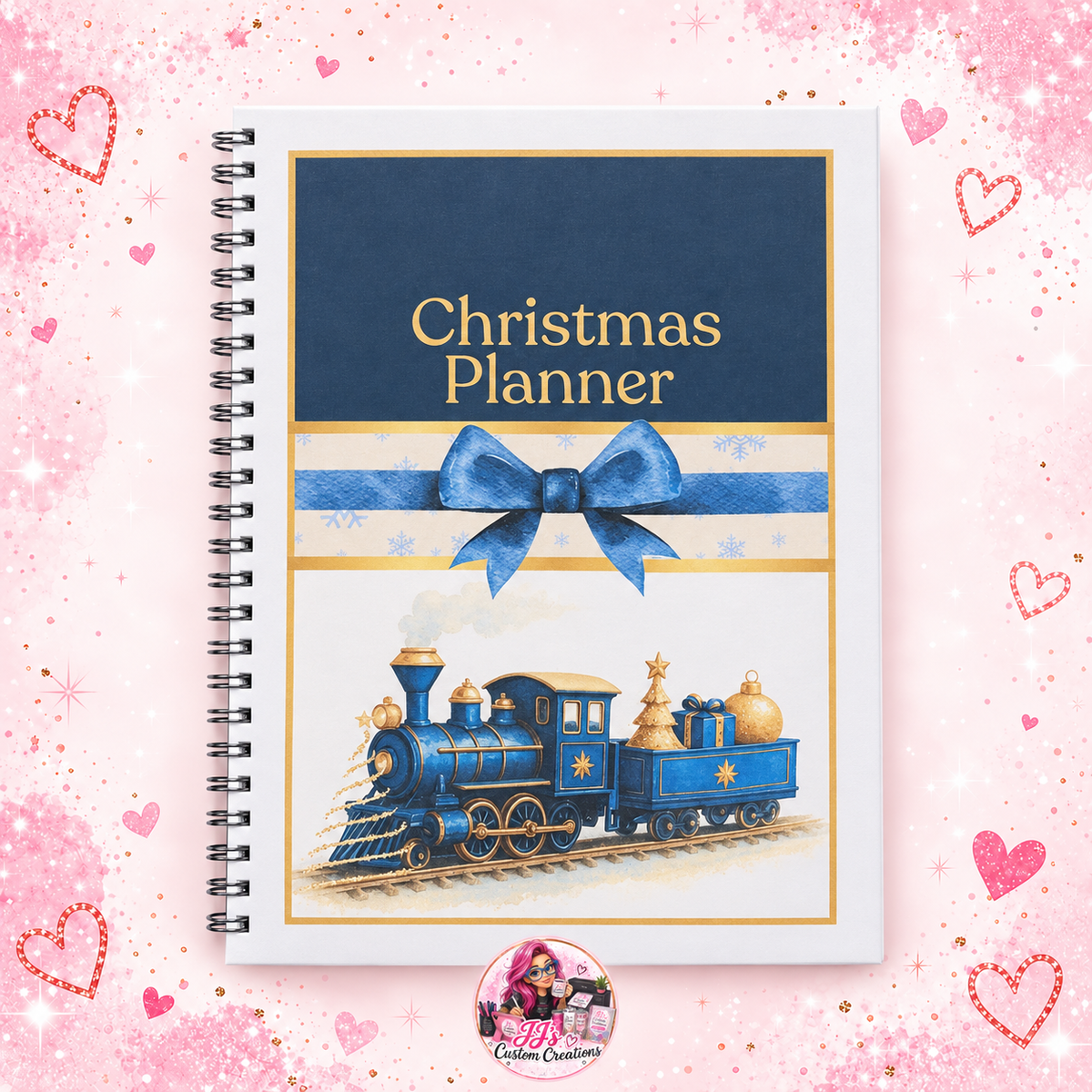 A4 wire-bound Christmas Planner on a full square pink sparkle background with JJ's watermark