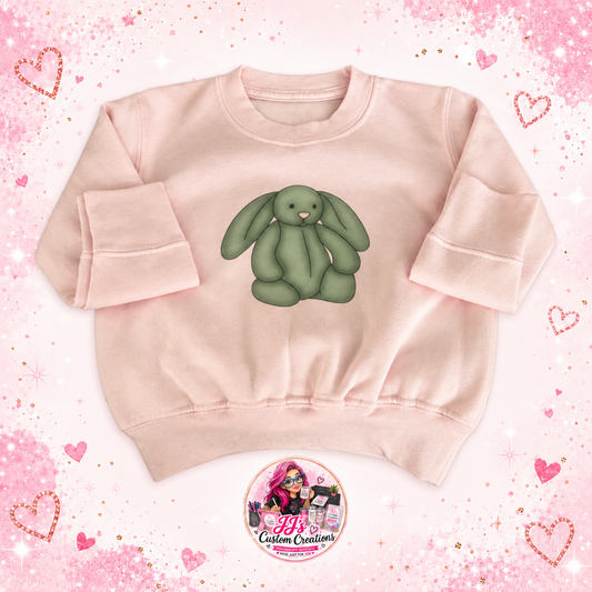 Pale pink baby sweatshirt with green floppy-eared bunny on a full square pink sparkle background with JJ's watermark