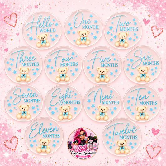 Complete blue baby milestone disc set from Hello World to Twelve Months on a square pink sparkle background