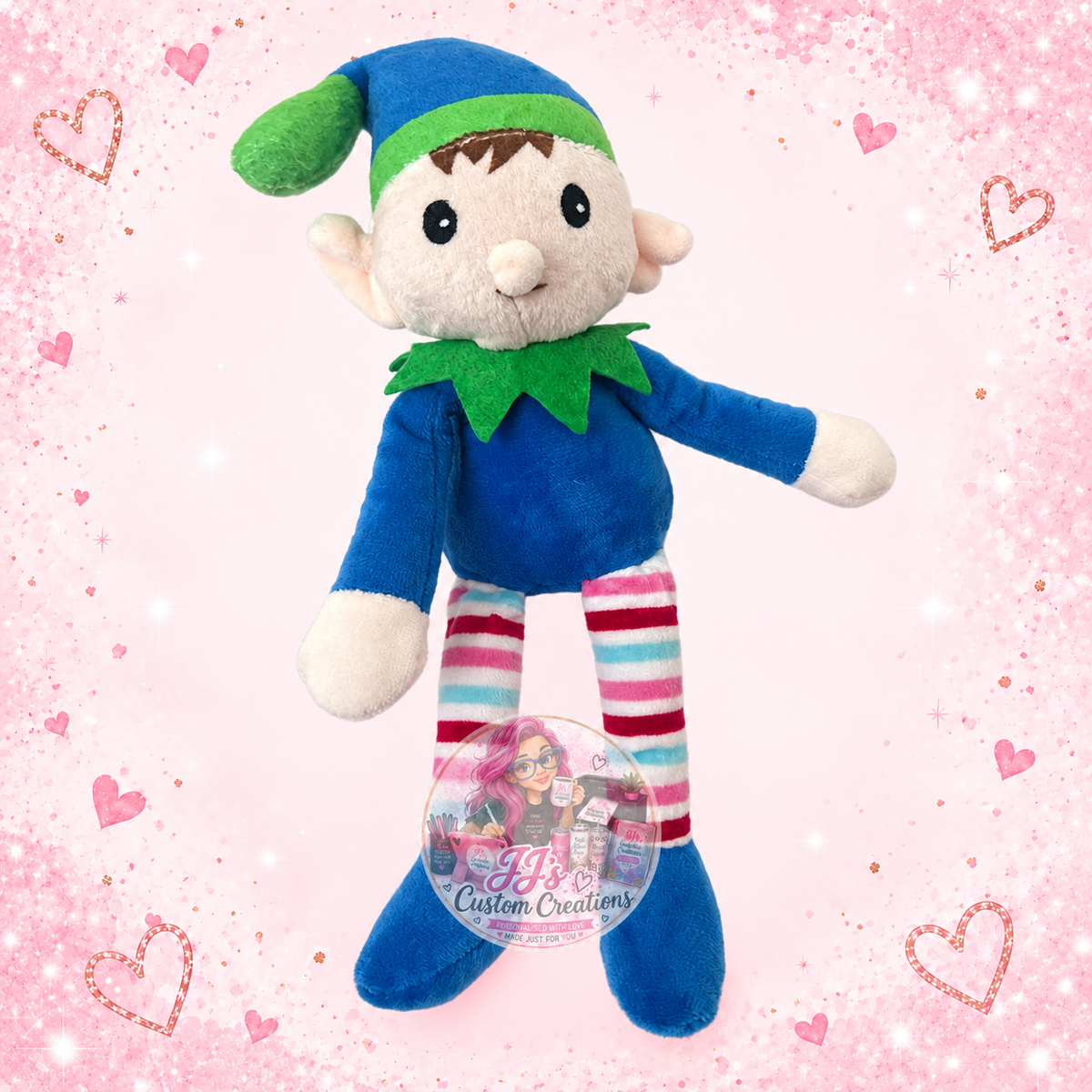 Blue and green personalised plush elf on JJ’s blush pink sparkle background