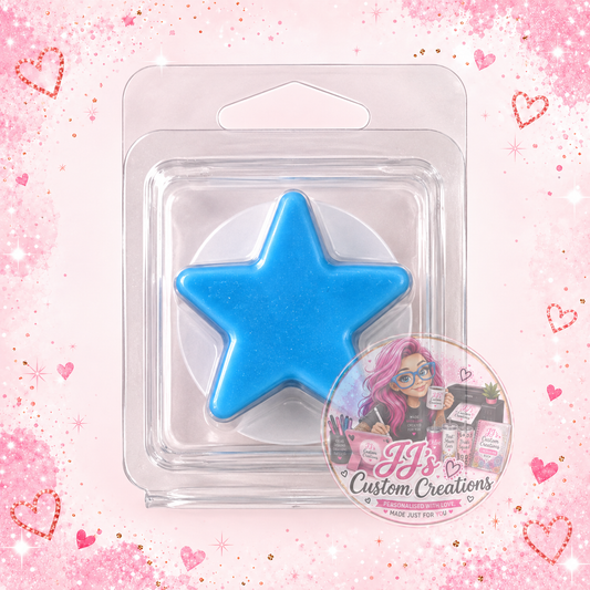 Blue star-shaped wax melt in clear clamshell on pale pink sparkle background with JJ's watermark