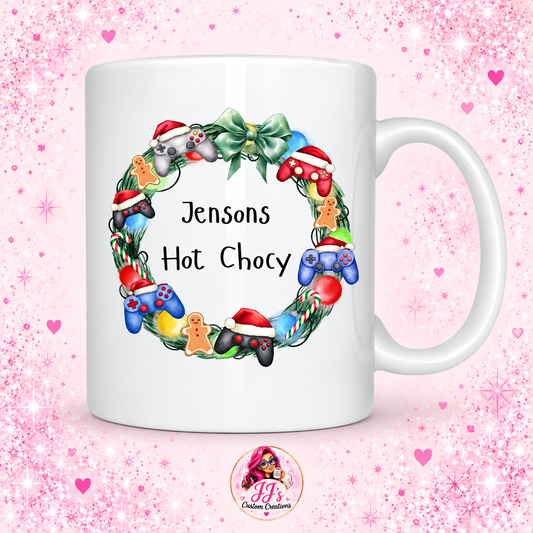 Christmas gaming mug with Jensons Hot Chocy design on a pink sparkle background