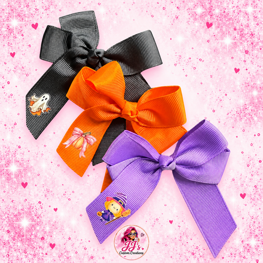Personalised Halloween hair bow set with black, orange and purple bows on a pink sparkle background