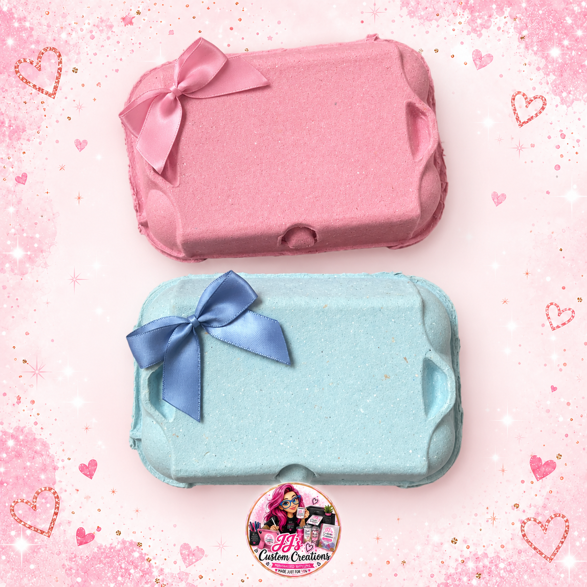 Blank pink and blue Easter egg boxes with matching bows on a full square pink sparkle background with JJ's watermark