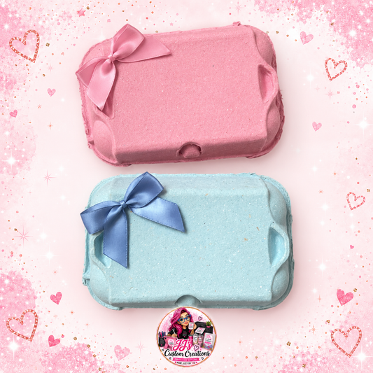 Blank pink and blue Easter egg boxes with matching bows on a full square pink sparkle background with JJ's watermark