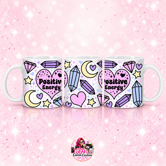 Positive Energy mug on JJ’s pale pink sparkle background with logo watermark