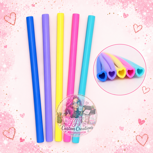 Five silicone heart straws in blue, purple, yellow, pink and light blue with heart-shaped openings, on pink sparkle background with JJ's watermark