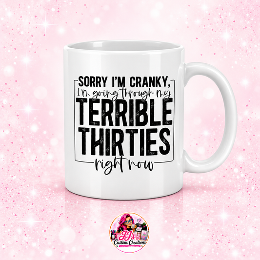 White Terrible Thirties mug on a light blush pink sparkle background